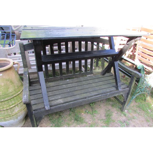 280 - A weathered teak two seat garden bench with slatted seat and back beneath an arched rail 122 cm wide... 