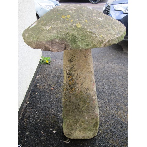 546 - A weathered natural limestone staddle stone and cap, 95cm high, 58cm diameter apprrox