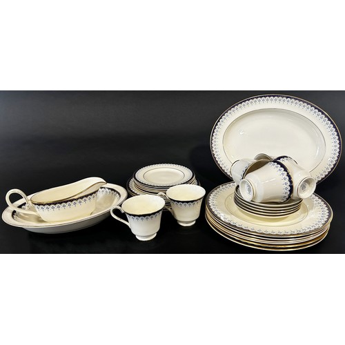 8 - A collection of Minton Consort tea and dinner ware for six with repeating blue and gilt detail