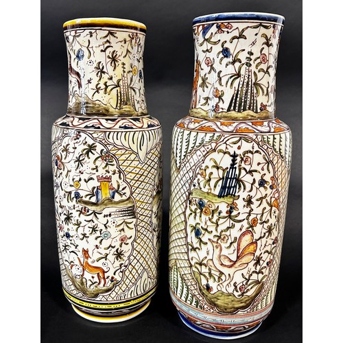 11 - A pair of Persian style vases of cylindrical form with hand painted detail showing wild animals, flo... 