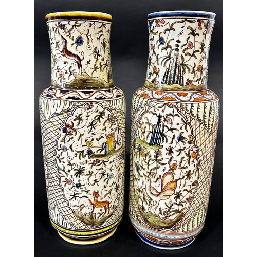 11 - A pair of Persian style vases of cylindrical form with hand painted detail showing wild animals, flo... 