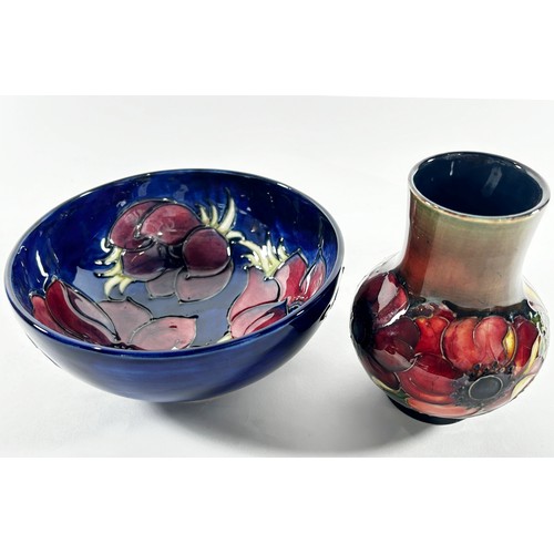 13 - A Moorcroft clematis pattern vase with drawn neck,13 cm in height together with a further  Moorcroft... 