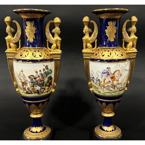 20 - A pair of Empire style vases the main bodies in a blue and gilt colourway with painted panels depict... 