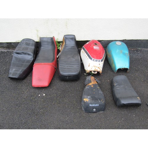 574 - Two motorcycle fuel tanks and five various seats