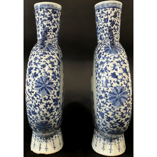 27 - A pair of large blue and white Chinese  moon flasks, Qing Dynasty showing characters in landscape wi... 
