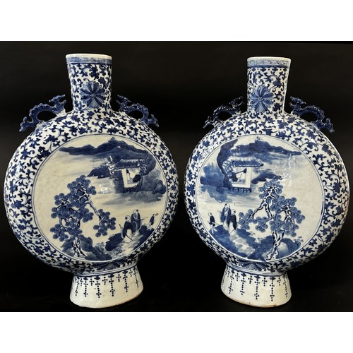 27 - A pair of large blue and white Chinese  moon flasks, Qing Dynasty showing characters in landscape wi... 