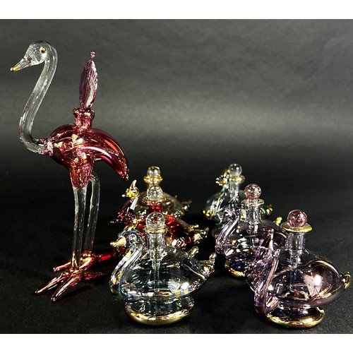 89 - Ten iridescent gilded blown glass  swan perfume bottles, together with a pink flamingo perfume bottl... 