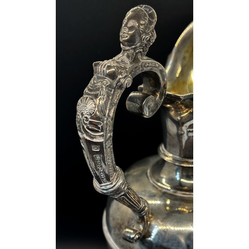 135 - A late Victorian silver claret jug with a scrolled female handle, London 1901 maker George fox, 30cm... 