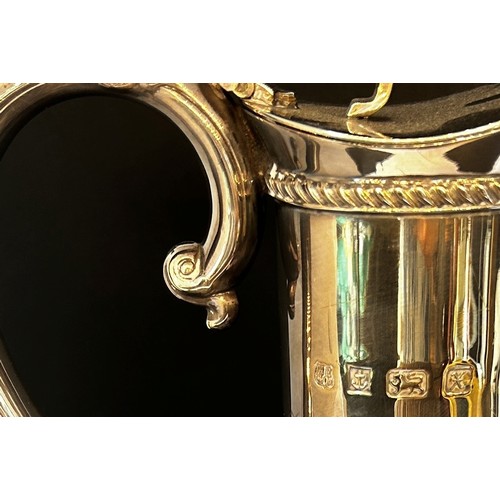 136 - A late 20th century cut glass Georgian style claret jug with a silver collar spout and handle, Birmi... 