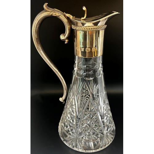 136 - A late 20th century cut glass Georgian style claret jug with a silver collar spout and handle, Birmi... 