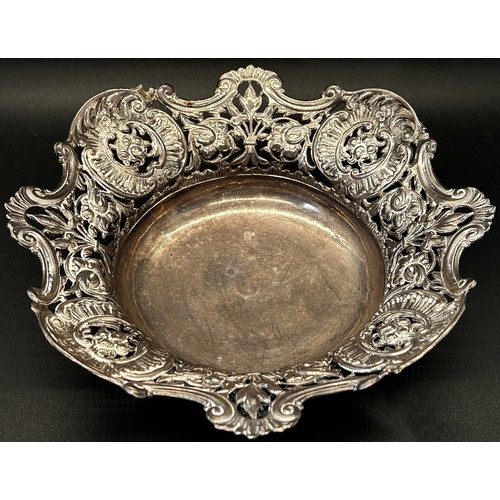 143 - A late Victorian silver dish with pierced floral sides, London 1895, makers marks rubbed, 17cm diame... 