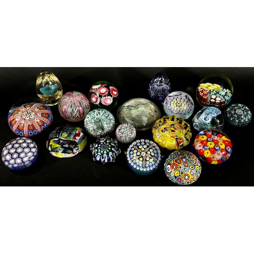 102 - A collection of 19, 20th century, glass paperweights in varying designs  Millefiori, flowers, bubble... 