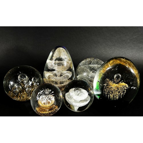 104 - A collection of 19th, 20th century, glass paperweights mainly of clear glass design, bubbles and swi... 