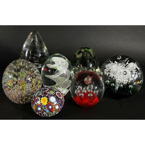 104 - A collection of 19th, 20th century, glass paperweights mainly of clear glass design, bubbles and swi... 