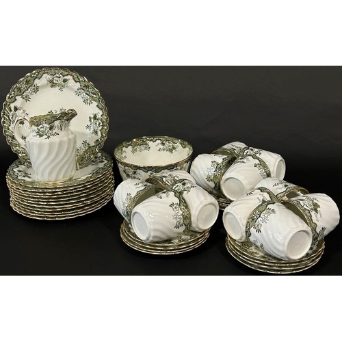 56 - A Victorian tea service for twelve with transfer printed green ground floral detail within gilded bo... 