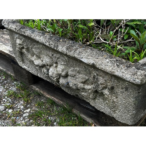 139 - A shallow weathered cast composition stone garden trough of square form with fruiting swag and lions... 