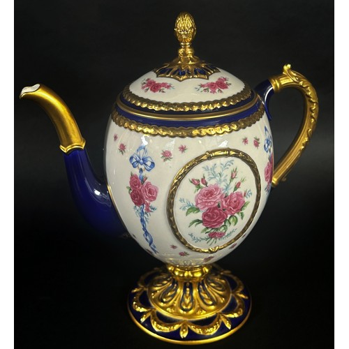 41 - A porcelain coffee pot - the Faberge egg imperial teapot, the ivory coloured body within a blue and ... 