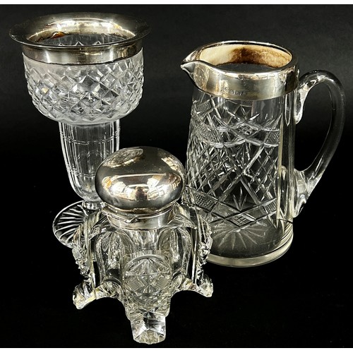 147 - A substantial cut glass inkwell with a silver hinged cap (chip to base)  cut glass jug with silver c... 