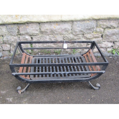 1012 - A simple good quality hand wrought iron fire basket on scrolled supports, 63cm x 31cm