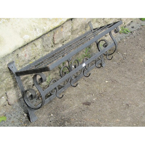 1021 - A decorative iron wall mounted hat and coat rack, 72cm wide