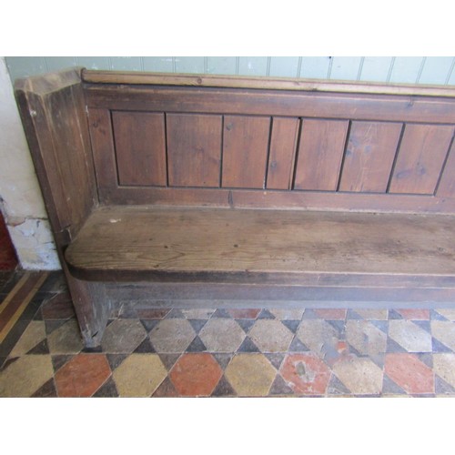 1022 - A large Victorian pine church pew with panelled back, 3.5m long
