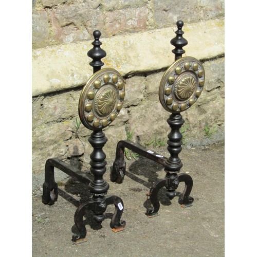 1026 - A large pair of country house iron fire dogs with cast brass panels of adjustable height with geomet... 