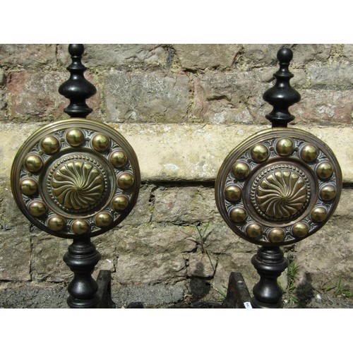 1026 - A large pair of country house iron fire dogs with cast brass panels of adjustable height with geomet... 