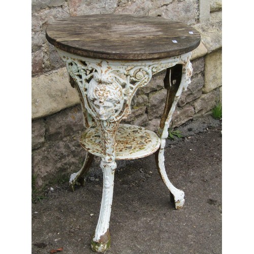 1032 - A Victorian cast iron pub table, circular with female mask detail, with weathered oak top, 51cm diam... 