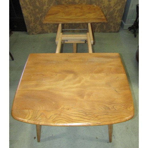 1118 - An Ercol extending dining table with additional folding leaf, elm table on square cut splayed suppor... 