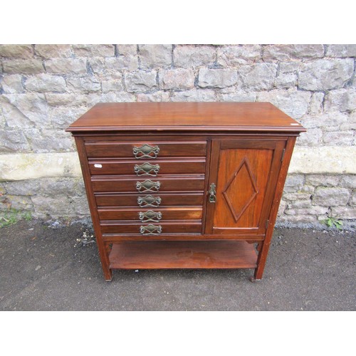 1122 - An Edwardian mahogany music cabinet enclosed by a series of 6 drawers and a side door