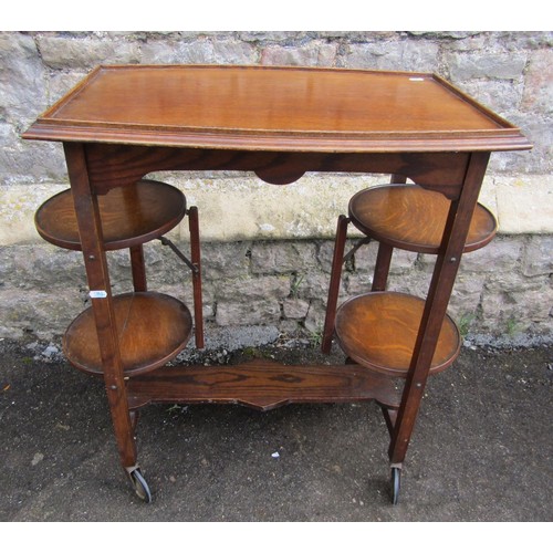 1123 - A patent oak tea trolley with folding cake racks, together with a pegged oak occasional table