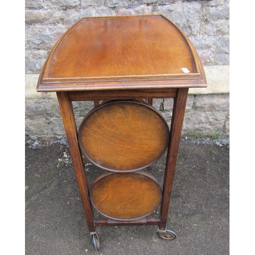 1123 - A patent oak tea trolley with folding cake racks, together with a pegged oak occasional table