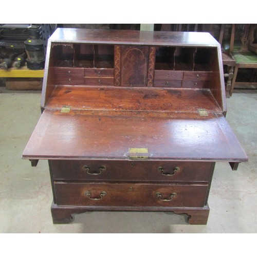 1139 - A Georgian mahogany bureau enclosing a fitted interior over two short and three long graduated drawe... 