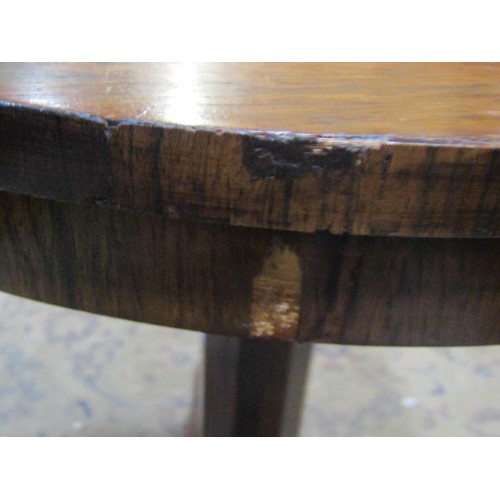 1147 - A small 19th century rosewood veneered occasional table of circular form raised on an octagonal pill... 