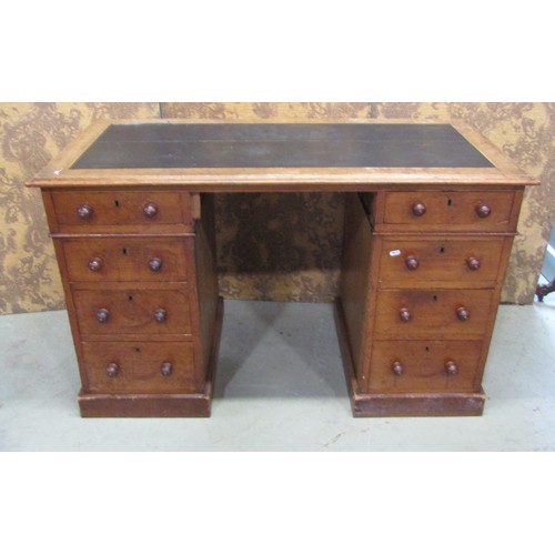 1179 - A Victorian oak pedestal desk of eight drawers with inset leather top, 122cm wide