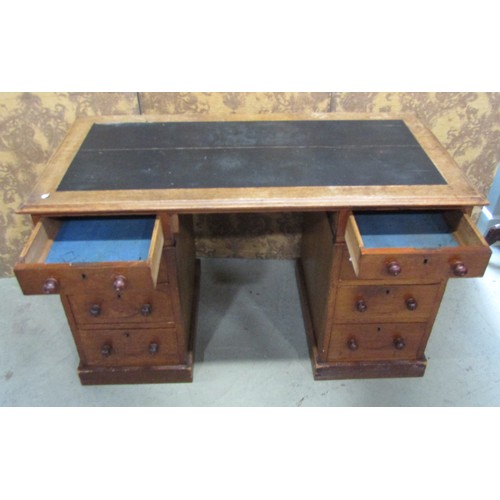 1179 - A Victorian oak pedestal desk of eight drawers with inset leather top, 122cm wide