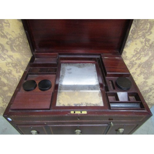 1197 - A Georgian mahogany gentleman's wash stand with rising lid, with comprehensively fitted interior, in... 