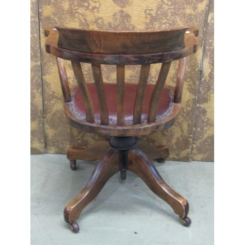 1221 - An Edwardian beechwood office chair with upholstered seat on a revolving base