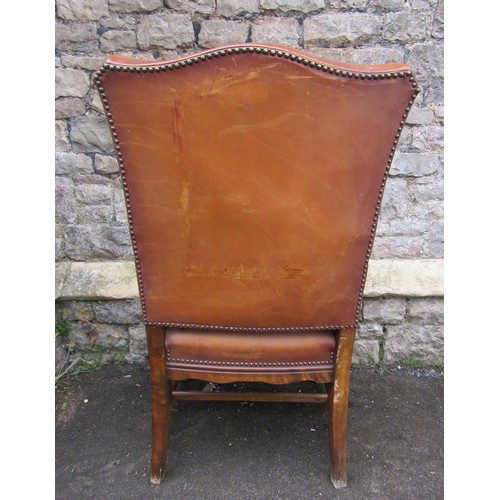 1229 - An open armchair in the Georgian style with tan coloured hide upholstered seat and back