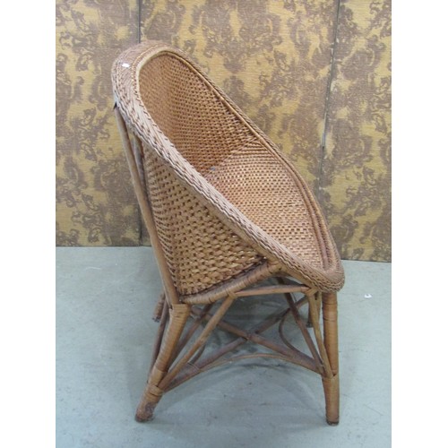 1243 - A vintage wicker two seat sofa, a mid century wicker plate glass occasional table of circular form a... 