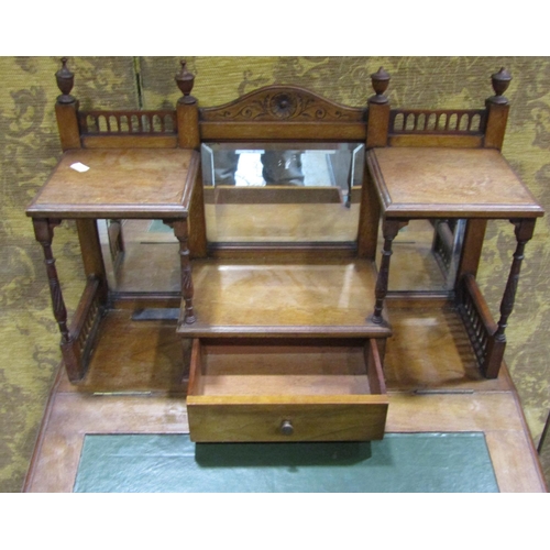 1162 - A late Victorian mahogany davenport with raised triple bevelled edge mirror back over the usual arra... 