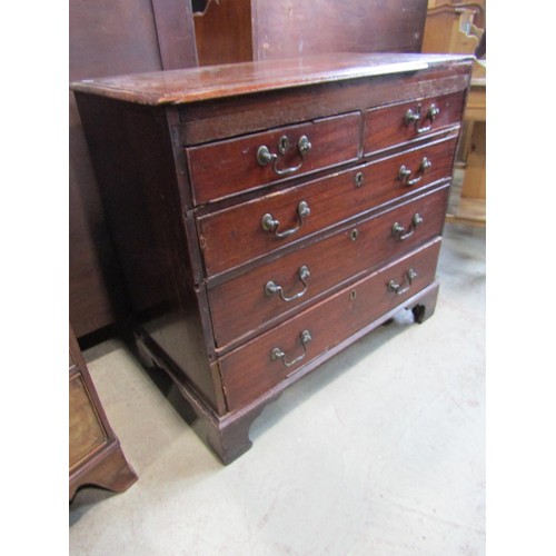 1191 - A Georgian mahogany bedroom chest of two short over three long graduated drawers set on bracket feet... 