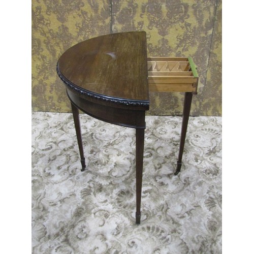 1210 - An Edwardian mahogany demi-lune fold over top card table in the Georgian style raised on square tape... 