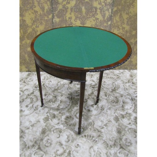 1210 - An Edwardian mahogany demi-lune fold over top card table in the Georgian style raised on square tape... 