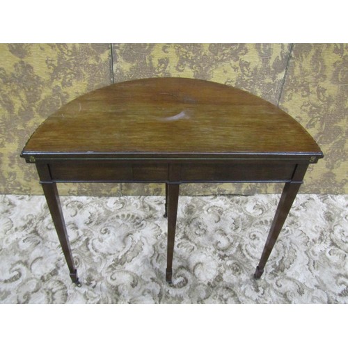 1210 - An Edwardian mahogany demi-lune fold over top card table in the Georgian style raised on square tape... 