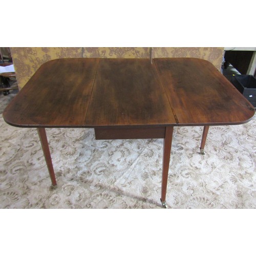 1212 - A 19th century mahogany drop leaf dining table raised on square tapered supports and brass caps and ... 