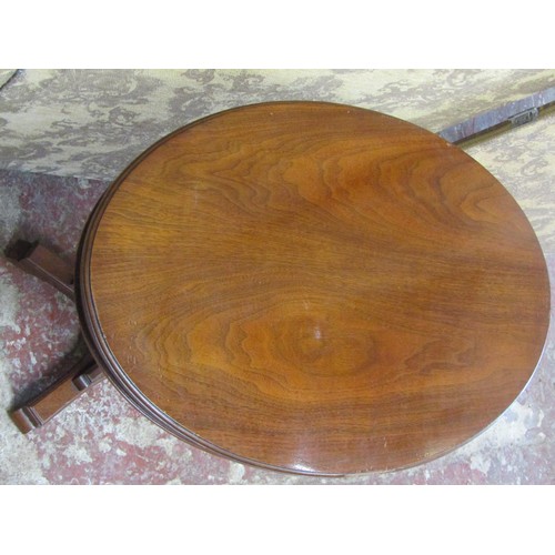 1213 - A late 19th century mahogany occasional table the oval top raised on a reeded tapering column and pl... 