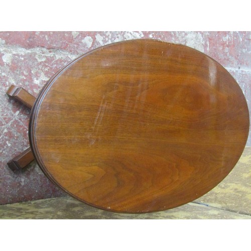 1213 - A late 19th century mahogany occasional table the oval top raised on a reeded tapering column and pl... 