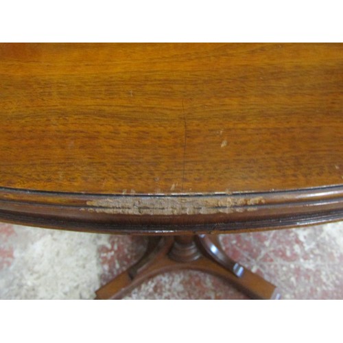 1213 - A late 19th century mahogany occasional table the oval top raised on a reeded tapering column and pl... 