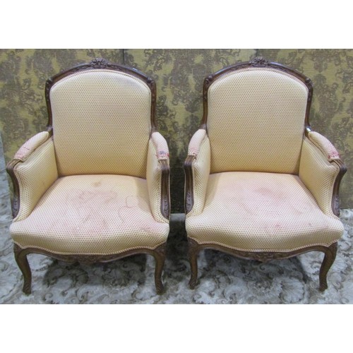 1223 - A pair of upholstered armchairs with carved show wood frames on cabriole supports